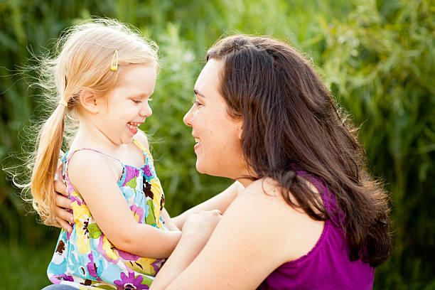 istock Happy Mother Hugging Her Daughter Outside On Summer Day 185266034