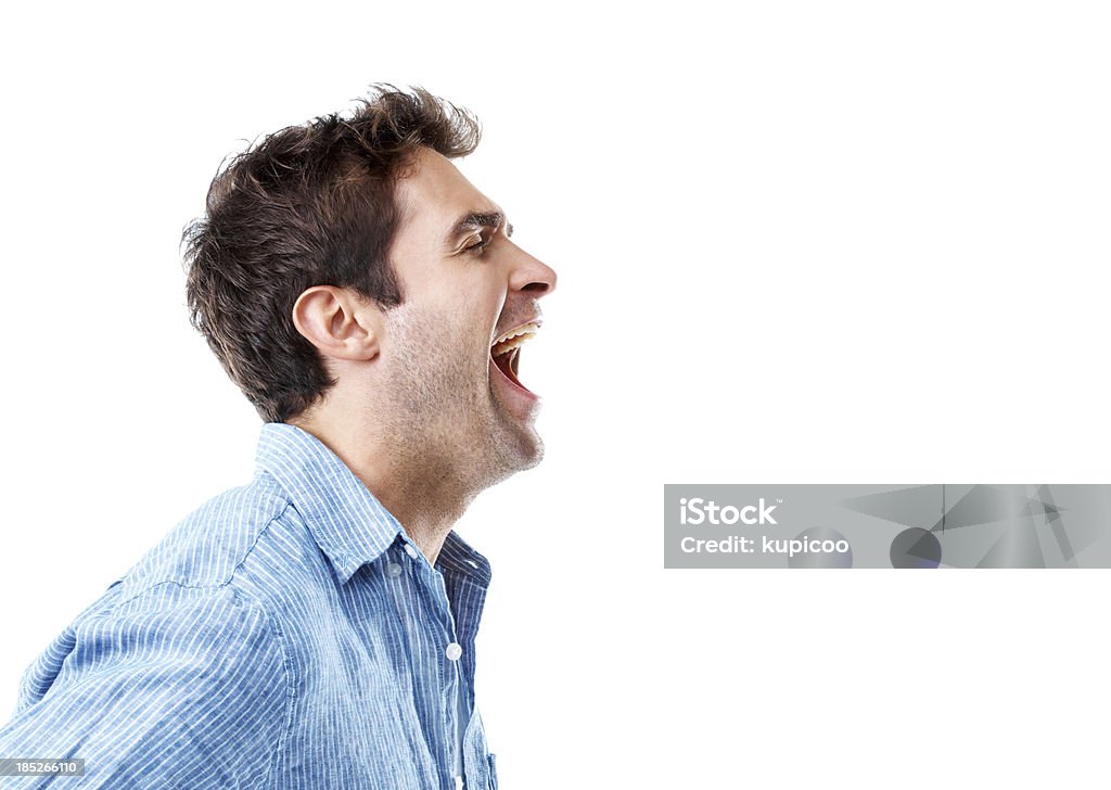 Let it all out! Handsome young man shouting into copyspace  while isolated on white Men Stock Photo