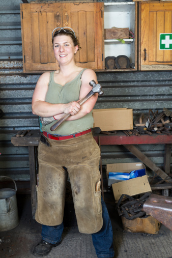 Portrait of a young female farrier.