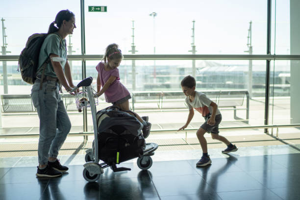 istock Mom with kids on airport 1852661277
