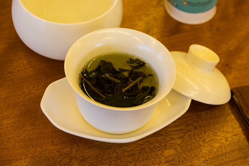 Tastings of dried tea leaves from around the world and a cup of hot brewed tea, a beverage that is a healthy drink. Varieties are from China, Japan, Sri Lanka, and India, and include green and black teas such as jasmine, oolong, gunpowder, darjeeling, roasted rice, and dragon well selections.