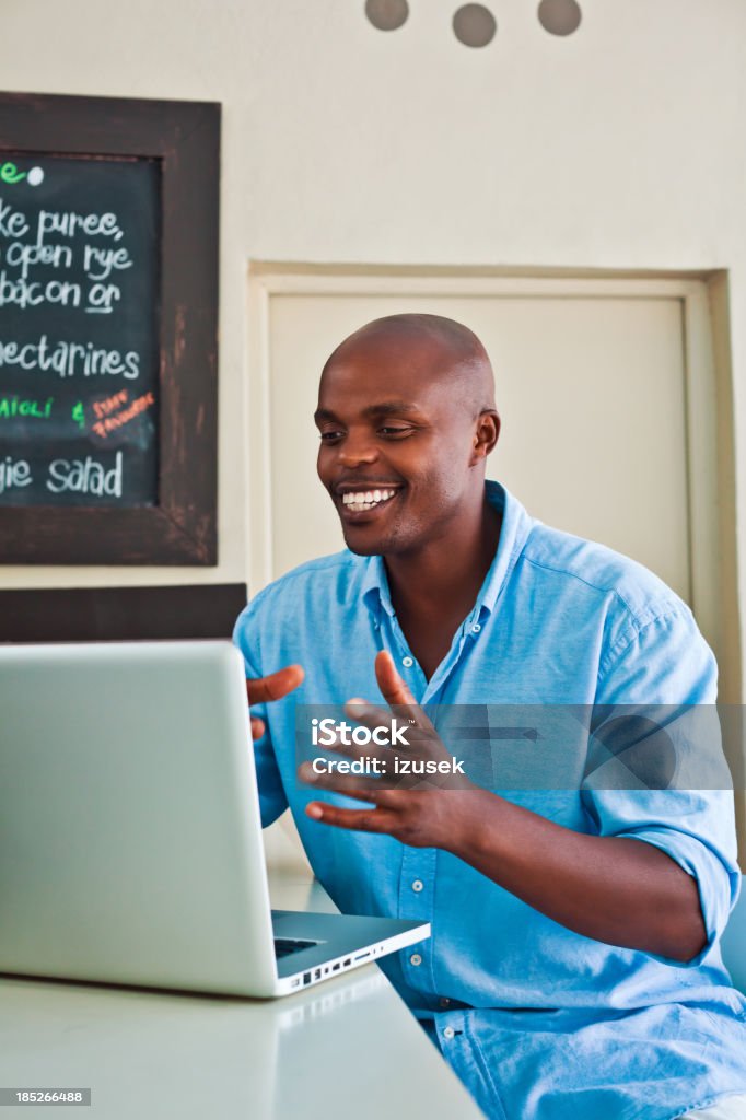 Internet dating Man using laptop in cafe and having video conversation. Adult Stock Photo