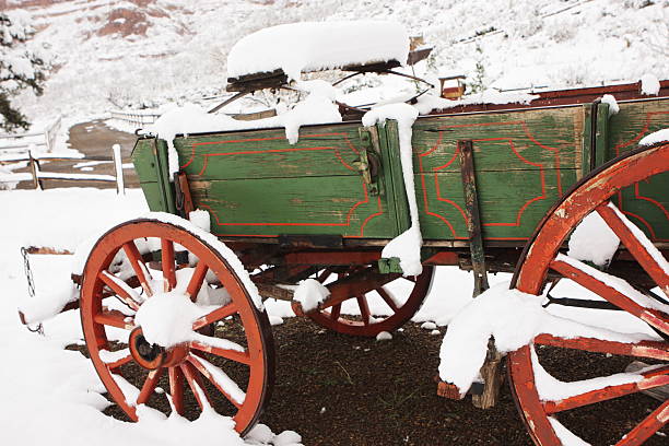 Wagon Wheel Stagecoach Carriage Cart "Carriage wagon during snowfall along country lane. Yavapai County, Arizona, 2012." covered wagon horse cart snow winter stock pictures, royalty-free photos & images