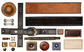 Set of leather elements. Isolated on white background. Collection of belt of black and brown color, leather tag and label, metal button and rivets, metallic decorative ornament