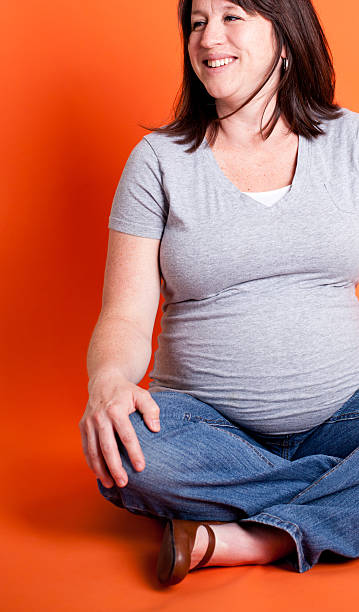 istock Young Pregnant Mother Isolated on Orange 185267193