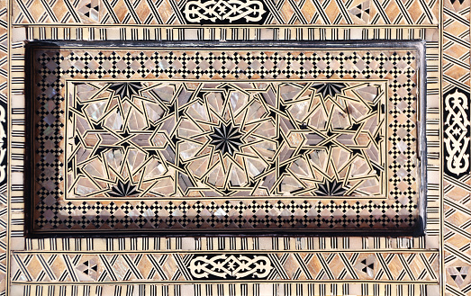 Detail of ancient mosaic window shutter with mother-of-pearl ornaments. Horizontal or vertical background with traditional moroccan tile decoration