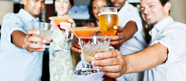 istock Five young adults socializing in a hotel bar over drinks 185267586