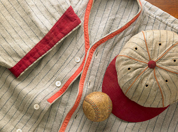 Old-time wool baseball uniform with cap and ball An antique pin-striped wool baseball uniform with a matching cap. Shot with an antique baseball. souvenir stock pictures, royalty-free photos & images