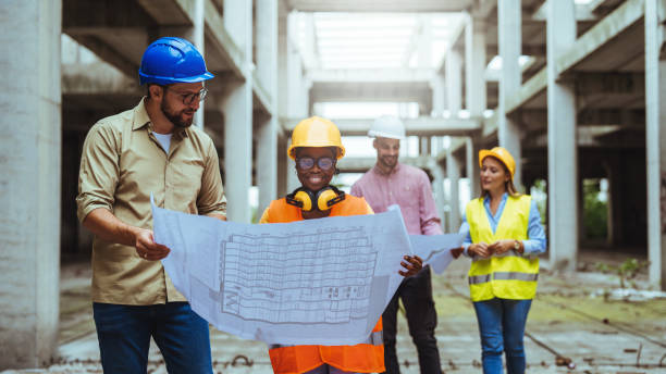 istock Comparing with the blueprints, a team of experts is evaluating the realization on the construction site. 1852677171