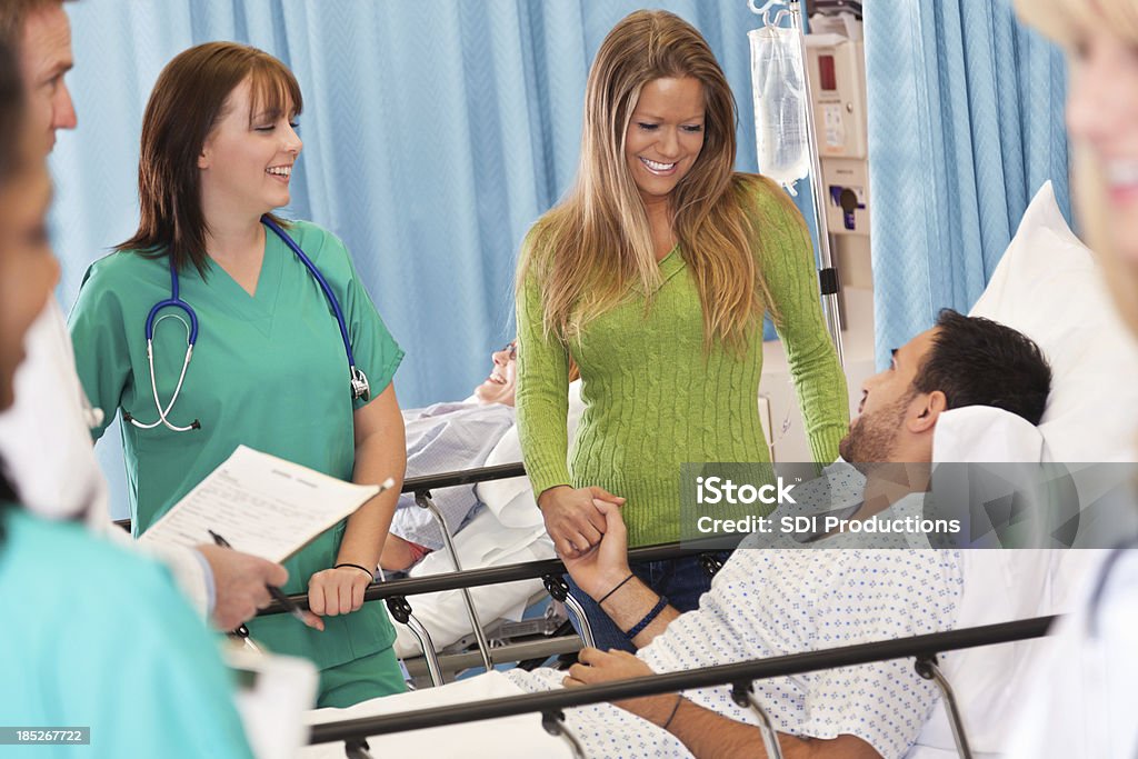 Marito confortante marito malato nel Letto da ospedale - Foto stock royalty-free di Donne