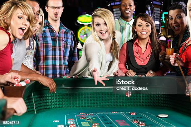 Happy Group Of Adults Gambling At Craps Table Stock Photo