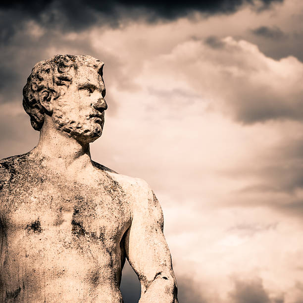 istock Ancient Male Statue against Stormy Clouds 185267895