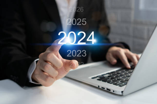 istock Businessman using computer with virtual 2024 year diagram. Business planning, trend change from 2023 to 2024, goals and investment. Happy new year concept 1852682560