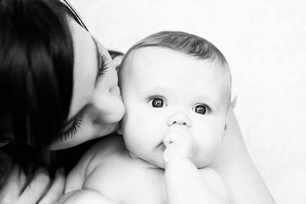 istock Mother Kissing Baby 185268361