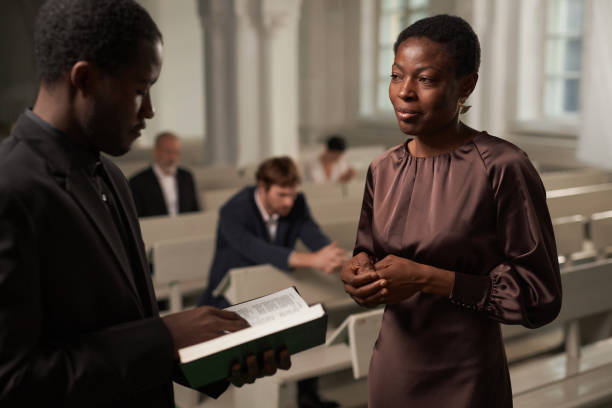istock Senior Woman Talking to Priest 1852685800