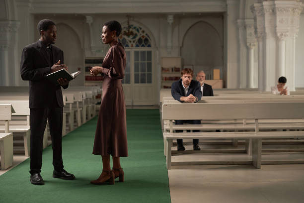 istock Priest Talking to Senior Woman 1852686342