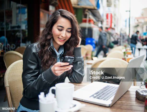 Sonriente Mujer Joven Mensajes De Texto Foto de stock y más banco de imágenes de Adulto - Adulto, Adulto joven, Alegre