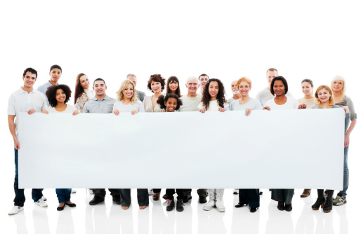 Large group of a cheerful people are holding a big paper for commercials.  They are isolated on white background.