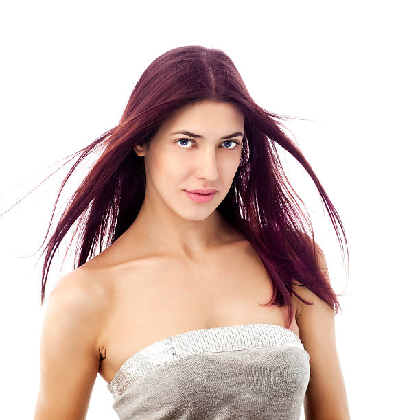 Beautiful young woman  on the wind "Beauty shot of long haired, young, beautiful, woman with her hair fluttering on the wind." purple hair stock pictures, royalty-free photos & images