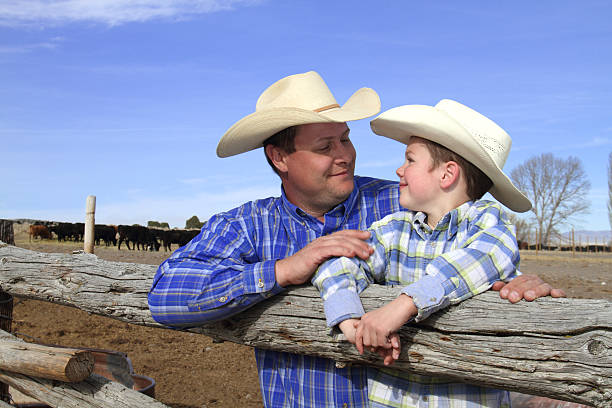 istock Father and Son Looking at eachother on their ranch 185269266
