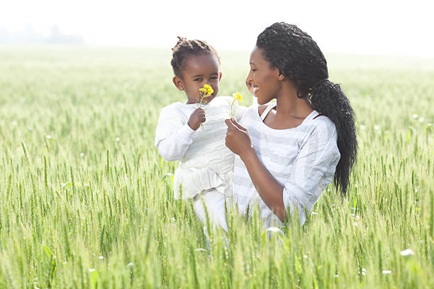 istock Black mother and daughter admiring spring flowers. 185269954