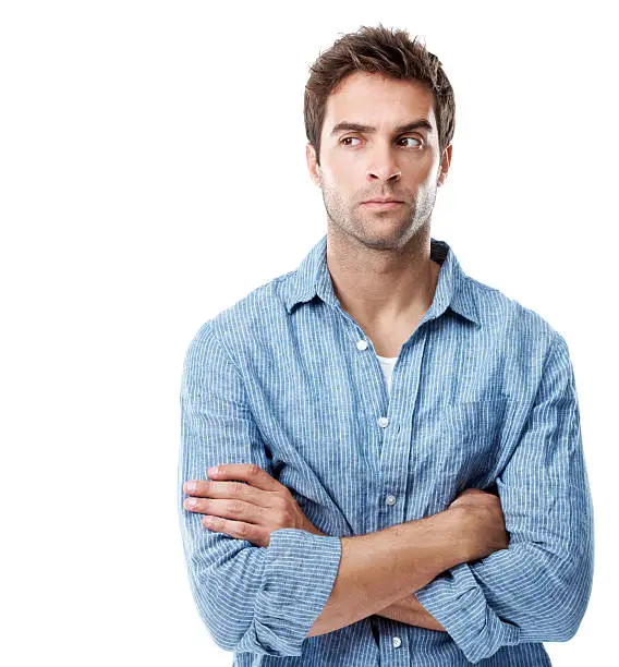 Handsome young man feeling suspicious while isolated on white