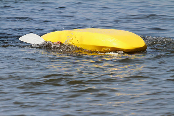 Overturned Kayak With Only a Hand Visible stock photo