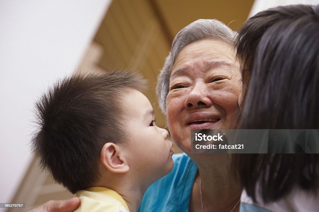 Grandmother's Love portrait of a grandmother being kissed by her grandchildren. Japanese Ethnicity Stock Photo