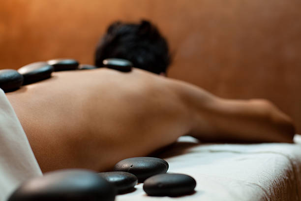 istock Close-up of warm stones on man's back 185271472