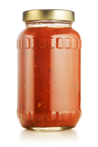 Jar of spicy tomato or marinara sauce isolated on white. More tomatoes in lightbox below...