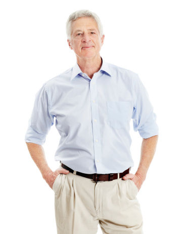 Senior man smiling with his hands in his pockets - isolated on white