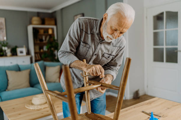 istock Senior man repairing his chair 1852718524