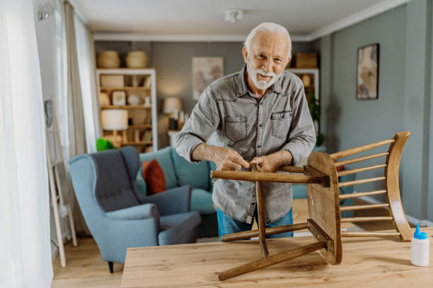 istock Senior man repairing his chair 1852719607