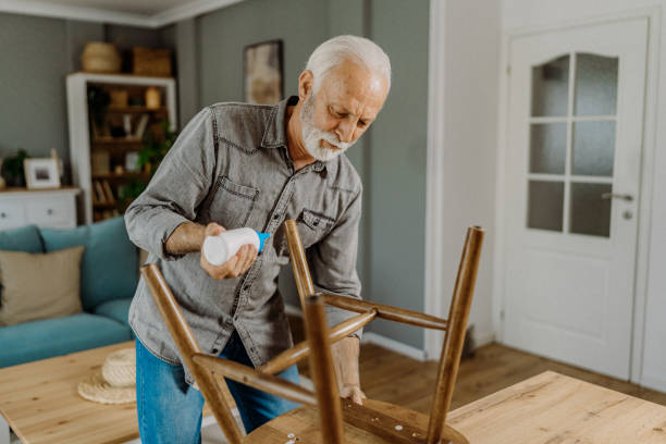 istock Senior man repairing his chair 1852719612
