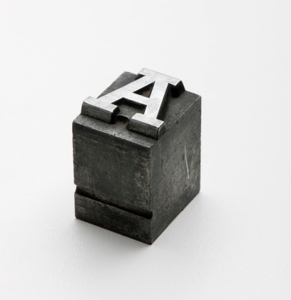 Old movable type Letter A on a white background.