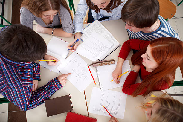 istock Group of college students studying together 185272915