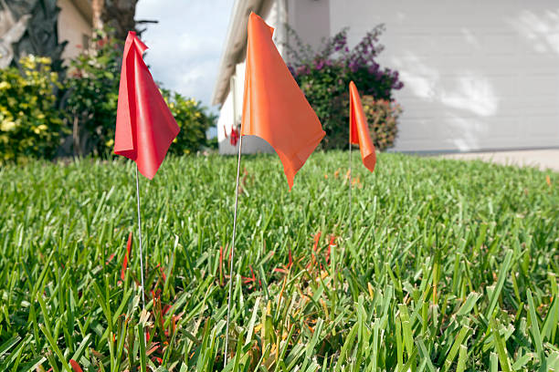 Flags marking underground utilities flags marking underground wires and cablesBuilding and Construction yard measurement stock pictures, royalty-free photos & images