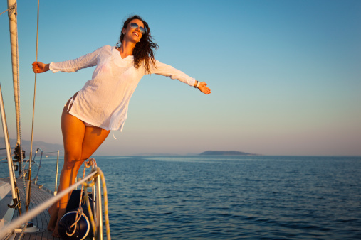 young attractive cheerful woman on a sailboat enjoying summer vacationsCHECK OTHER SIMILAR IMAGES IN MY PORTFOLIO....