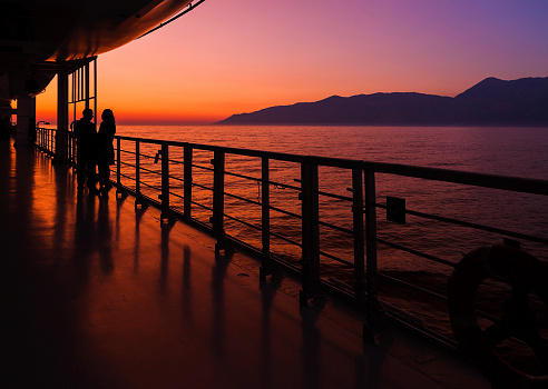 couple on a cruise ship at sunset