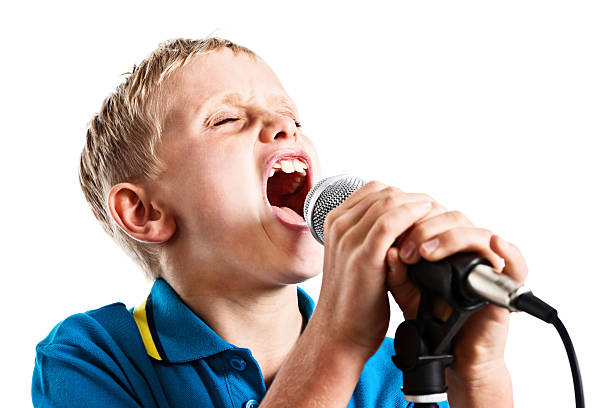 istock 9 year old blond wannabe pop star sings into microphone 185273403