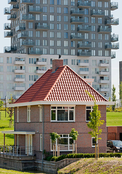 istock detached house in front of apartment building 185273405