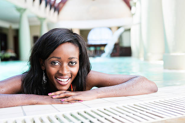 istock Smiling young woman relaxing in indoor spa pool 185273433