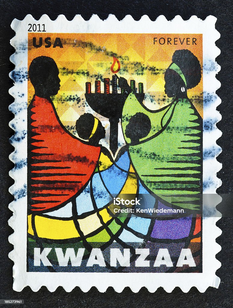 Kwanzaa Stamp "Kwanzaa is a non-religious holiday that takes place over seven days beginning each year on December 26 and ending January 1. Kwanzaa draws on African traditions. .The colors in the stamp art represent the colors of the Kwanzaa flagaagreen for growth, red for blood, and black for the African people. These same colors are repeated in the candles that are lighted each night of the holiday." Kwanzaa Stock Photo