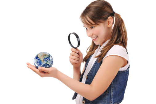 Cute young girl examining the earth with a magnifying glassMany thanks to NASA to let me use this image.flickr-NASA Goddard Photo and Video