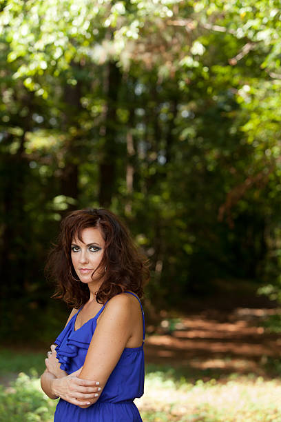 Attractive brunette in the woods. stock photo