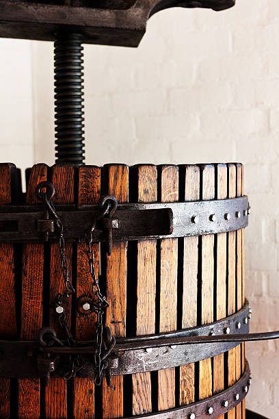 Close up on the adjustment mechanisms of a beautifully preserved antique wine press.