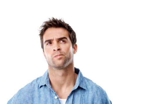 Handsome young man looking thoughtful while isolated on white - copyspace