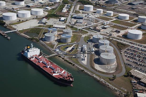 Aerial View of Crude Oil Tanker and Storage Tanks Crude oil tanker discharging crude oil to storage tanks oil tanker stock pictures, royalty-free photos & images