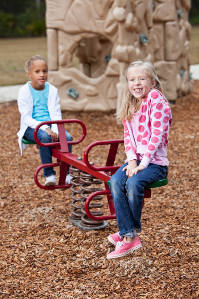 istock Girls on playground seesaw 185275868