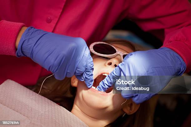 Jovem Menina Sos Seus Dentes Flossed Por Higienista Dentário - Fotografias de stock e mais imagens de 6-7 Anos